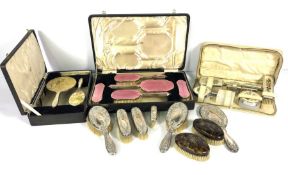 Assorted vanity cases, including cased enamel and silver backed hair brushes etc, once with pink