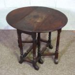 An early 18th century provincial walnut gateleg table, the compact drop leaf oval top on turned