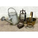 A vintage brass preserving pan, together with assorted items including two irons, a galvanised