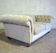 A good vintage Chesterfield two seat sofa, circa 2000, with button back and currently upholstered in