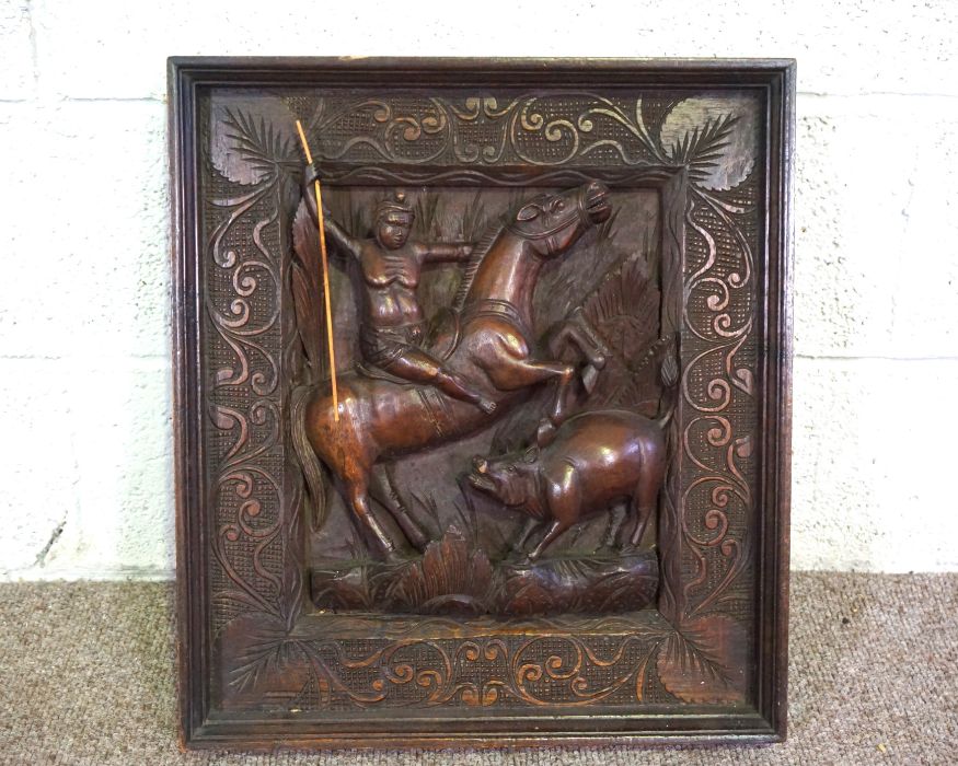 A modern Indian panel depicting a man on horseback hunting a wild pig, 52cm x 47cm