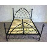 A modern double bed frame, with sprung slat base and ‘gothic’ style bed ends, 146cm wide, 120cm high
