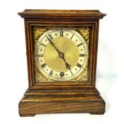 A small oak mantel timepiece, signed by Hamilton & Inches, Edinburgh, with a silvered chapter ring