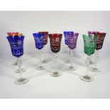 A set of eleven flash coloured and cut glass wine goblets, with bowls in blue, green, ruby,
