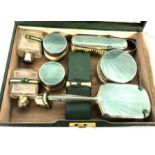 A vintage green leather travelling case, and matching vanity case, with silver and enamel by