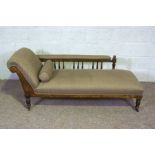 An Edwardian chaise longue, with walnut turned feet and bobbin turned back supports, currently