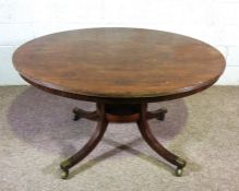 A George IV mahogany breakfast table, circa 1825, with a circular tilt top, set on a pedestal with