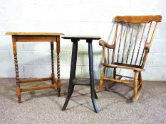 A modern comb backed rocking chair, with eight spindles, together with a small occasional table