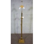 A modern gilt metal column standard lamp; together with a nest of Regency style tables and three red