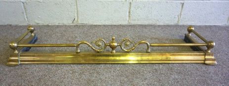 A Victorian brass fire curb, with ball corner points and central foliate scroll crest, 120cm wide