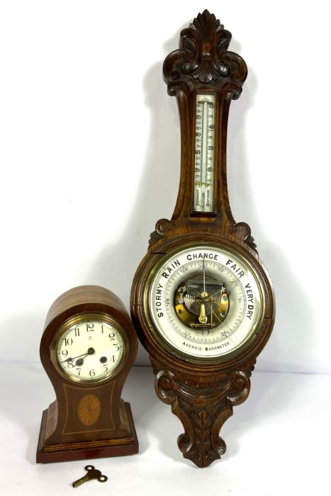 An Edwardian balloon top and inlaid mantel clock, 29cm high; And a Victorian oak cased aneroid