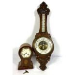 An Edwardian balloon top and inlaid mantel clock, 29cm high; And a Victorian oak cased aneroid