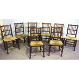 A set of eight beechwood provincial dining chairs, Sussex style turned spindle backs, with rush