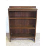 A small open front oak bookcase, circa 1930, with three shelves, 98cm high, 76cm wide