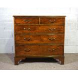 A George III style mahogany veneered chest of drawers, 20th century, with two short and three long