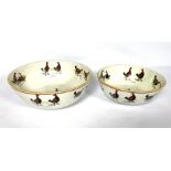 A pair of Staffordshire creamware bowls, each decorated with Cockfighting scenes, early 19th