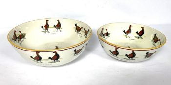 A pair of Staffordshire creamware bowls, each decorated with Cockfighting scenes, early 19th