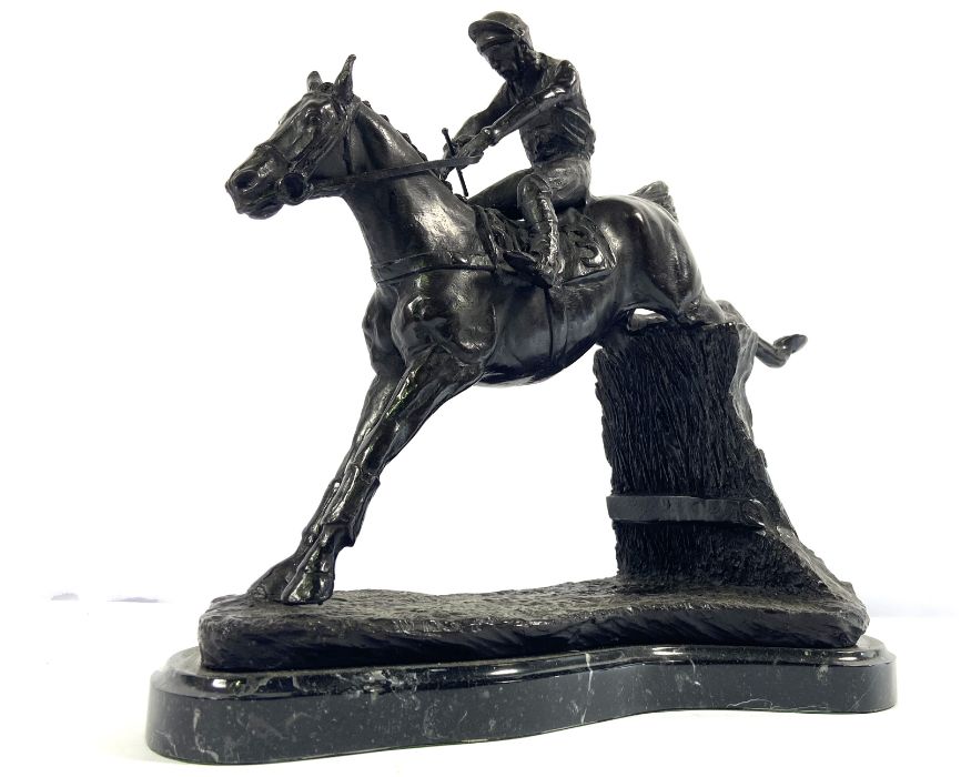 British School, Red Rum, with Jockey Up, taking a fence, unsigned bronzed figure group, 32cm high,