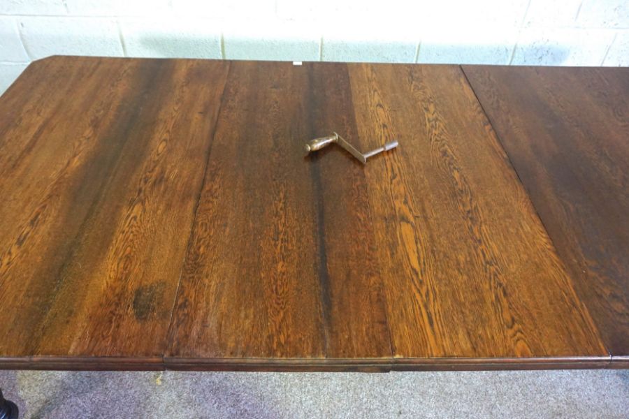 An Edwardian oak extending dining table, early 20th century, with a solid top, on four ring turned - Image 2 of 3