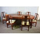 A Chinese hongmu or hardwood dining suite, including an extending oval dining table, and a set of