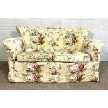 A small two seat upholstered sofa, currently upholstered with floral decoration, 135 cm wide
