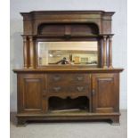A large late Victorian oak sideboard, circa 1900, with a high mirrored gallery back, flanked by