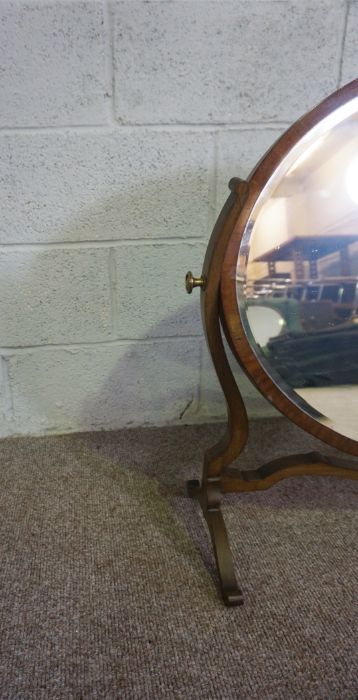 An Edwardian oval mirror on stand, with carved supports, 73cm high, 82cm wide; and another oval - Image 3 of 10