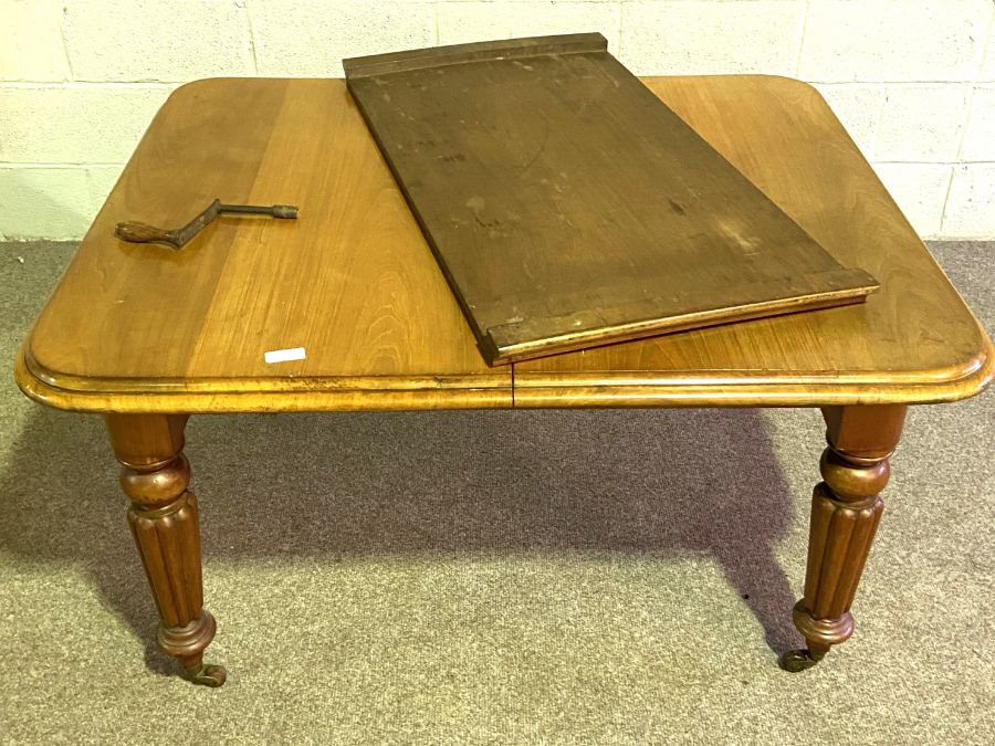 A Victorian mahogany extending dining table, with additional leaves set on for ring tanned and lobed