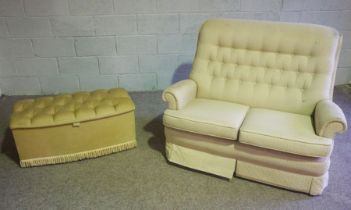 A modern two seat sofa, with beige upholstery, together with a small upholstered ottoman (2)