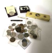An assortment of commemorative coins, a commemorative tin,  two penknives and a pair of cufflinks (