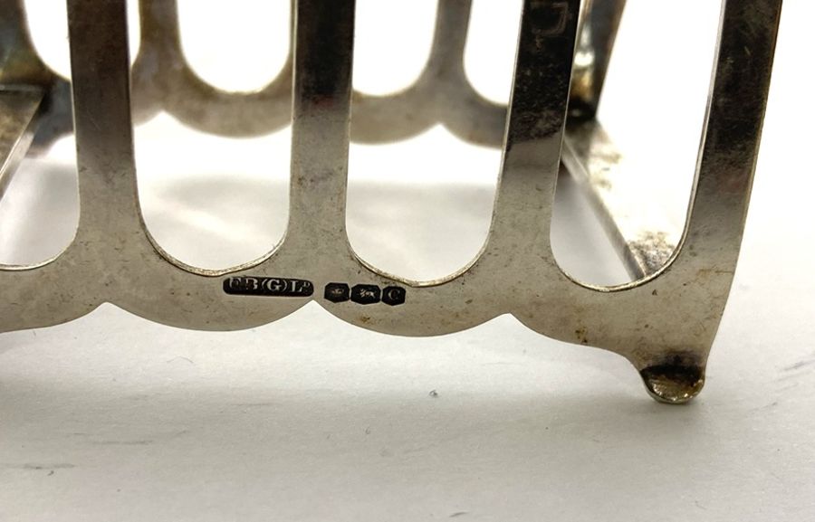 A pair of Edwardian silver toast racks, Sheffield 1920; together with another smaller toast rack; - Image 8 of 10