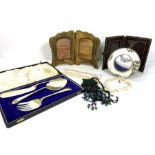 A group of miscellaneous objects, including decorative bead necklaces; a folding photo frame,