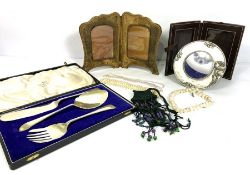 A group of miscellaneous objects, including decorative bead necklaces; a folding photo frame,