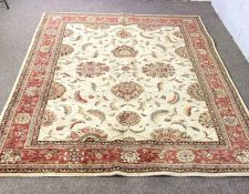 A modern Persian style rug, with flower heads on a cream ground, within umber border, 294cm x 228cm