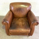 A large vintage leather armchair, 20th century, with deep back and scrolled arms, set on brass