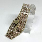 A 9 carat gold bracelet, in yellow and rose gold, multi link chain, 18cm long, marked 375, 16g