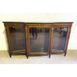 A late Victorian inlaid mahogany breakfront bookcase, circa 1900, with three bevelled glass