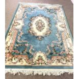 Six assorted decorative rugs, including a French style blue carpet, decorated with flowers; also a