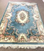 Six assorted decorative rugs, including a French style blue carpet, decorated with flowers; also a