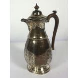 A Queen Anne style silver jug, hallmarked Birmingham 1922, of bulbous form with mid rib and domed