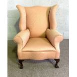 A George III style wing backed armchair, currently upholstered in pink. 97cm high