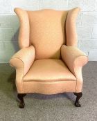 A George III style wing backed armchair, currently upholstered in pink. 97cm high