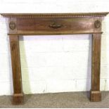 A vintage Adam style stained pine fire surround, 20th century, with dentil cornice, urn centred