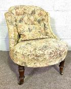 An Victorian style small upholstered nursing chair, with floral buttoned back and brass castors