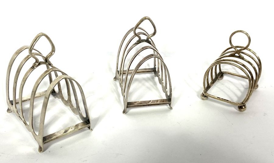 A pair of Edwardian silver toast racks, Sheffield 1920; together with another smaller toast rack; - Image 7 of 10