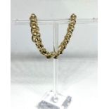 A 9 carat gold curb chain bracelet, (link behind clasp marked 375), 21cm long, 19.5g