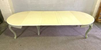 A vintage extending oval dining table, with cream painted top, cabriole legs and sage green
