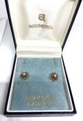 A pair of Mikimoto cultured pearl and gold ear studs, the pearls within loop flower heads, back