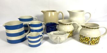 Assortment of decorative ceramics, including four graduated Cornish ware jugs by T Green; a puffin
