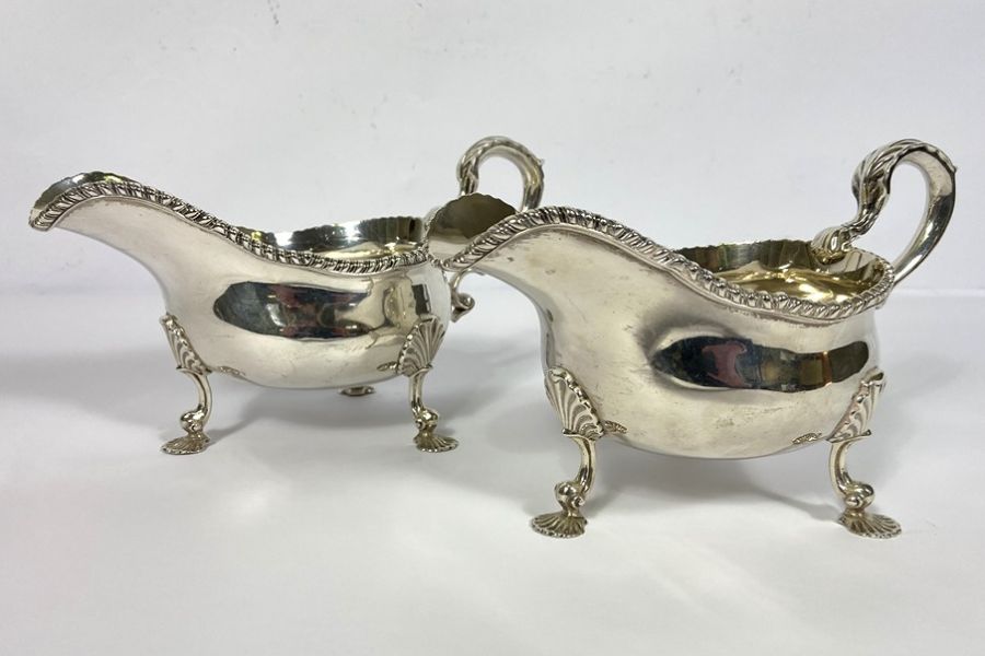 A fine pair of Edwardian silver sauce boats, hallmarked London 1903, Daniel & John Wellby, each with